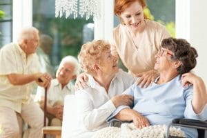 A group of elderly people in a wheelchair.