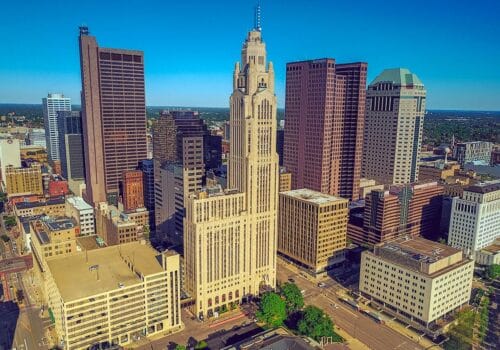 An aerial view of a city with tall buildings.
