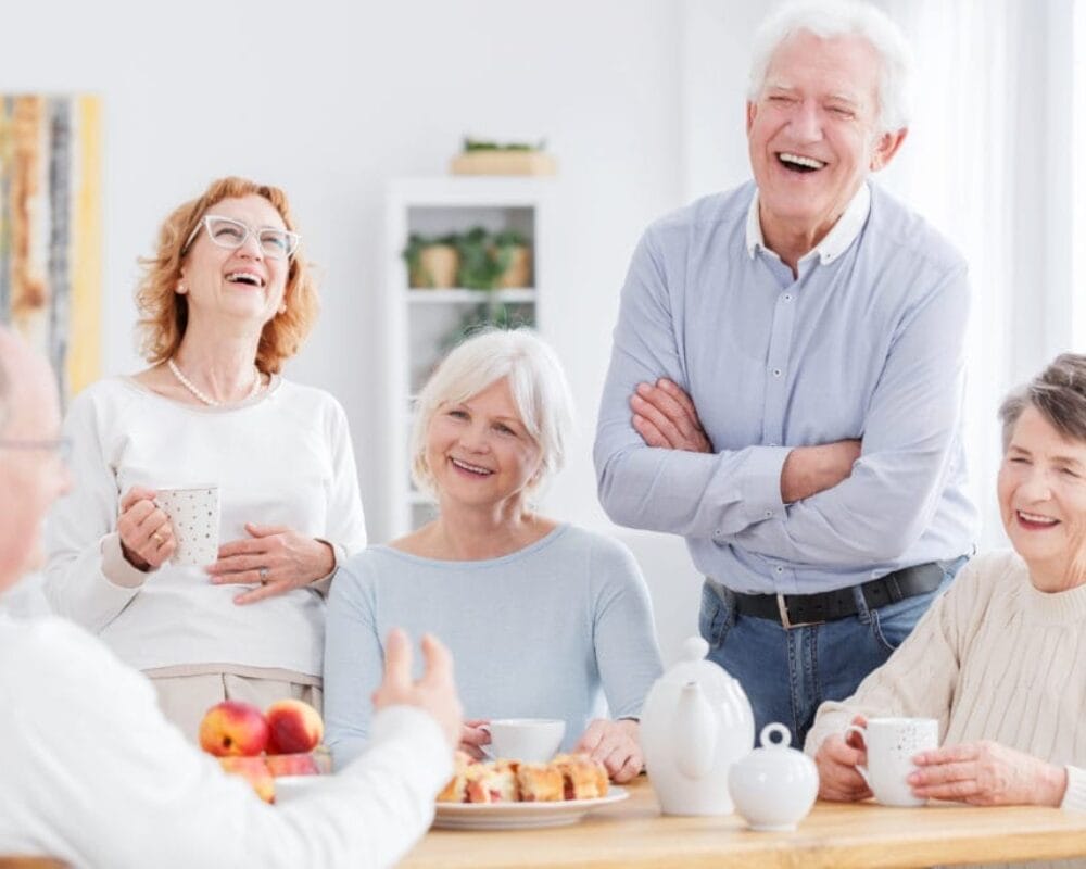 A group of older people laughing together.