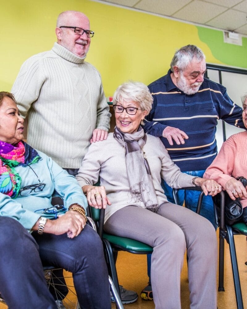A group of elderly people sitting in a wheelchair. A group of elderly people sitting in a wheelchair.